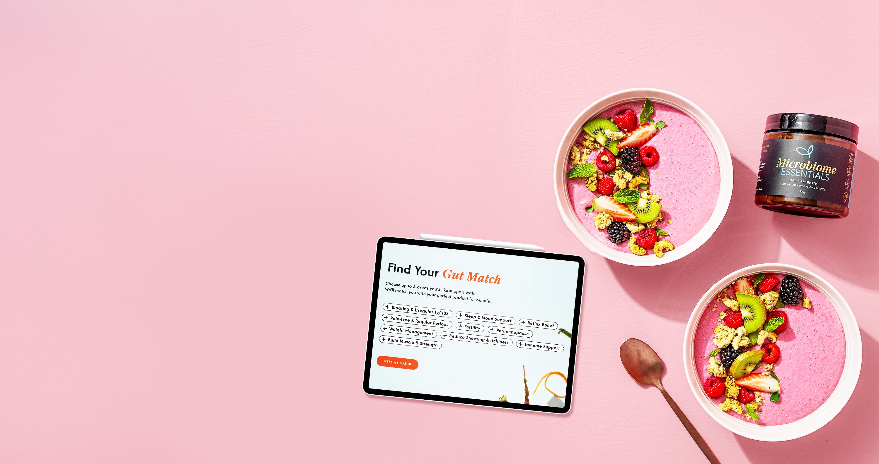 Two bowls of fruit salad with a tablet displaying Find Your Gut Match quiz on a pink background