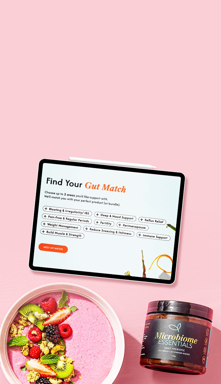 Tablet displaying Find Your Gut Match quiz with a bowl of fruit and a jar labeled 'Microbiome Essentials' on a pink background.