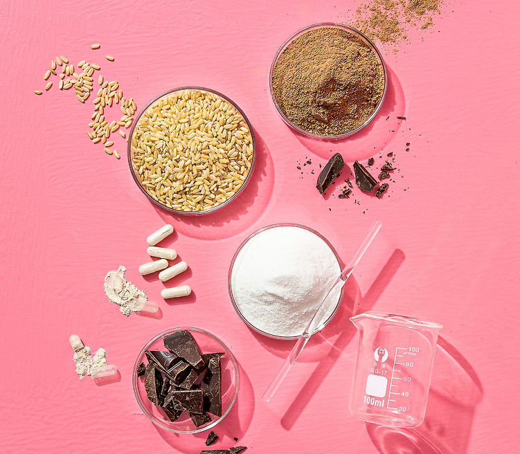 Various food ingredients and kitchen tools on a pink background